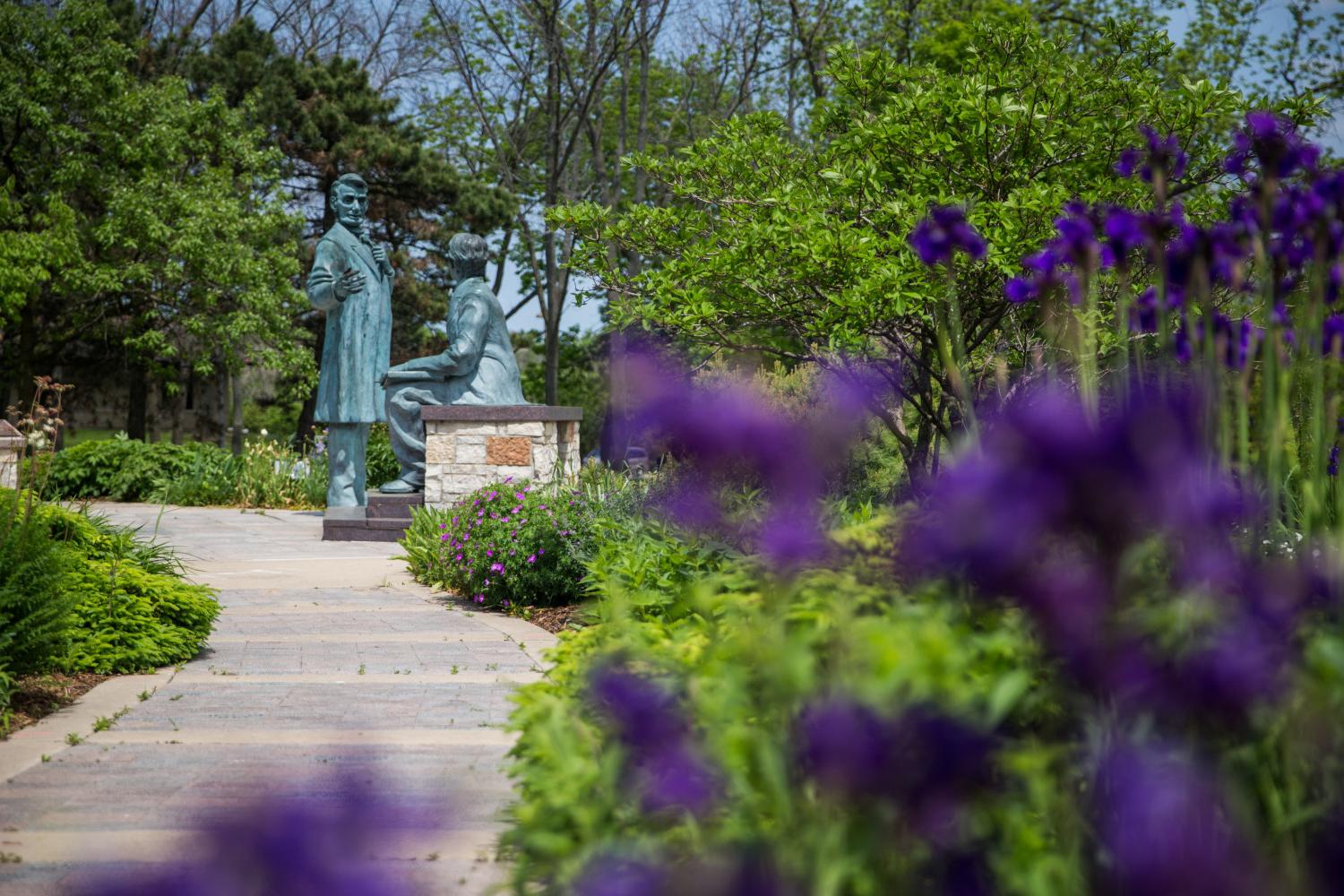 A spring look at the Learning Moment statue on Campus Drive.